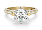 Load image into Gallery viewer, A round-cut moissanite engagement ring with a gold band and pavé set accent stones along the top and arched side.