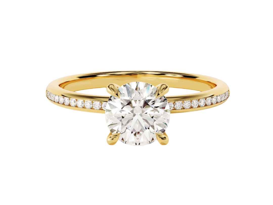 A round cut moissanite engagement ring with channel set sidestones, featuring a gold band and a central moissanite stone, surrounded by smaller moissanite stones set in channel settings.