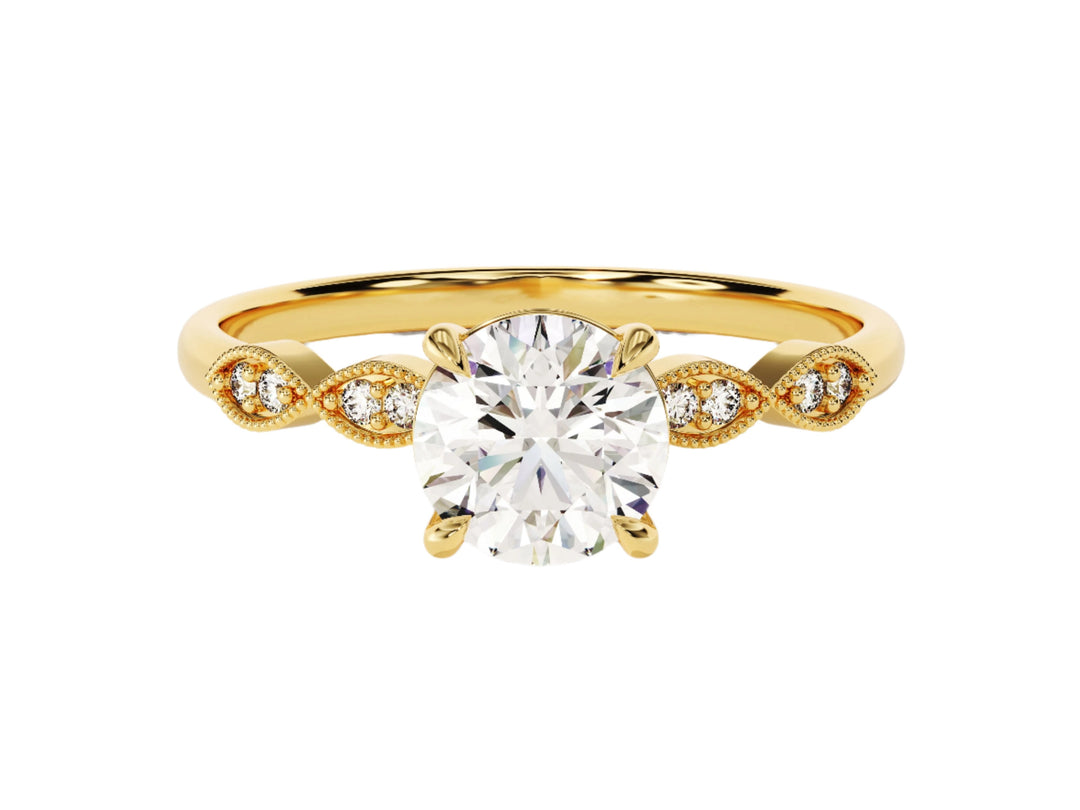 A round cut moissanite engagement ring with milgrain accented double round sidestones, set in a white gold band.