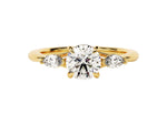 Load image into Gallery viewer, A round cut three stone moissanite engagement ring set in a 14k gold band