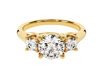 A gold-colored, three-stone round moissanite engagement ring with two smaller round accent stones