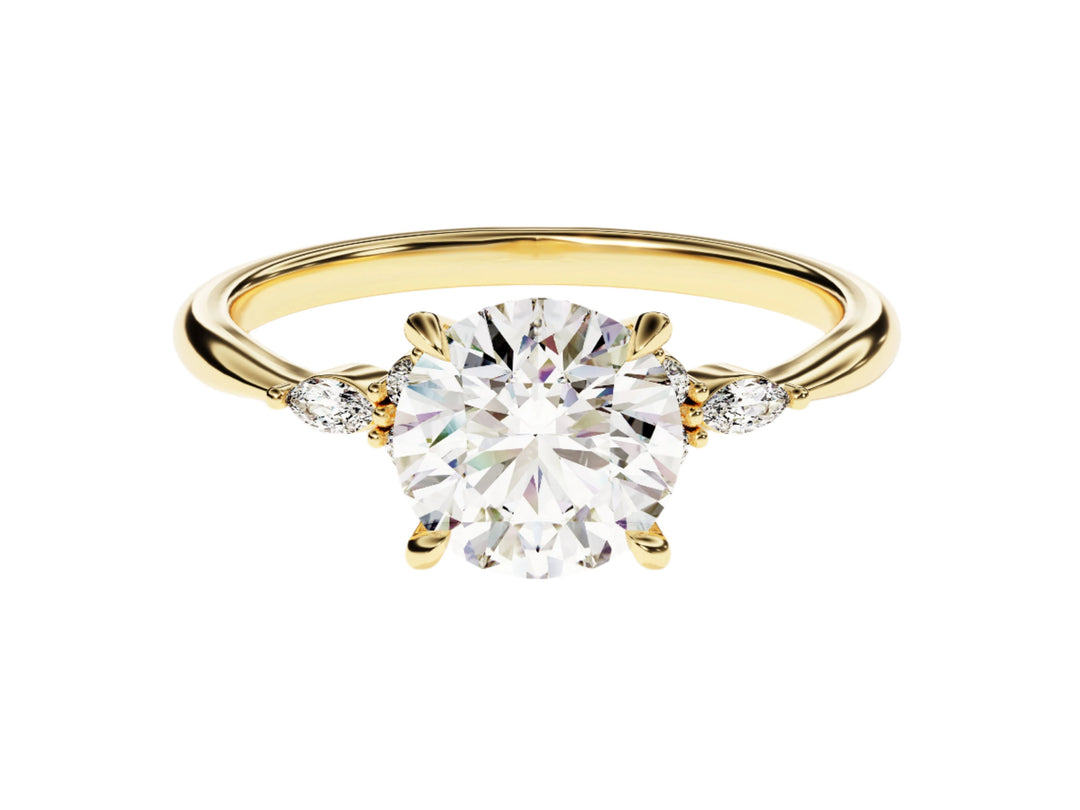 A round cut moissanite engagement ring with accent stones set in a gold band
