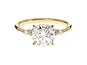 A round cut moissanite engagement ring with accent stones set in a gold band