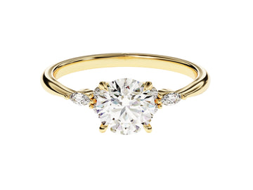 A gold-banded ring with a round cut moissanite center stone and smaller round accent stones on the band.