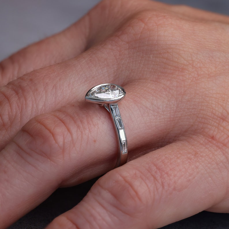 Three quarter view of the ring showing the channel set accent baguettes