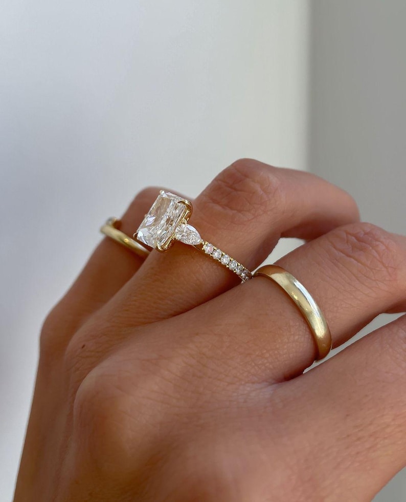 Side profile of radiant 3.0tcw lab grown diamond ring featuring a graceful cathedral shank, delicate pave diamonds, and a hidden halo beneath the center stone. A romantic and eco-conscious engagement ring or anniversary gift, designed for brides who appreciate refined brilliance.