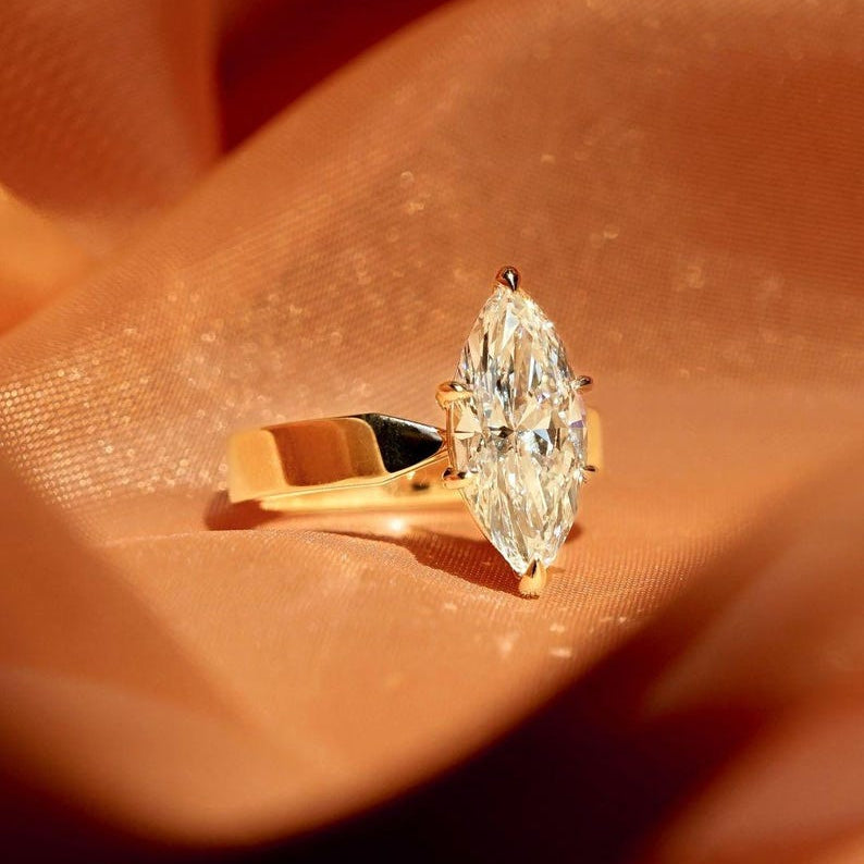 Stunning 2.50ct marquise cut lab grown diamond engagement ring featuring a unique flair shank design. This eye-catching bridal ring is perfect for weddings, anniversaries, or romantic gifts. A sustainable and stylish diamond ring that beautifully celebrates love for her or your special girl.