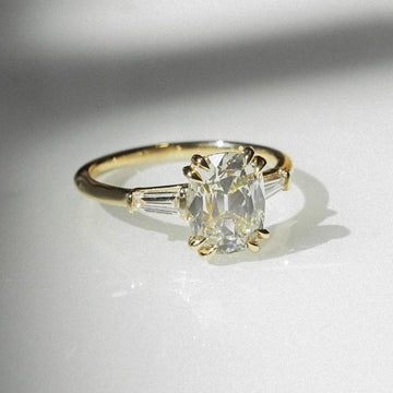 Cushion cut 1.60ct lab grown diamond engagement ring featuring a double claw three stone setting and bold dome shank design. A forever classic ring perfect for anniversaries or birthdays, this ethically crafted diamond ring for her offers timeless beauty and modern elegance.