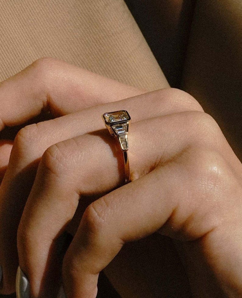 3.0tcw Asscher lab grown diamond ring with a full bezel setting and side stone detailing, IGI certified. A perfect forever engagement ring or wedding ring, designed to blend contemporary minimalism with classic Art Deco-inspired sparkle for women who value refined elegance.