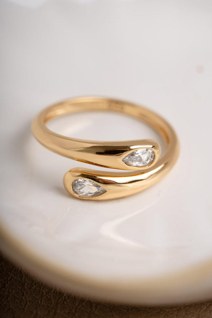 Gold dainty stacking ring on white surface