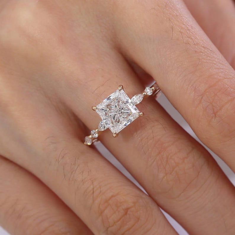 four prong engagement ring
four prong setting
gold prong ring
gold prong setting
sparkling gold ring
sparkling engagement ring
brilliant princess cut
brilliant cut gemstone
clear moissanite ring
clear gemstone ring
crystal clear ring
luxury moissanite
premium moissanite
diamond alternative ring
ethical engagement ring
conflict free ring
eco friendly ring
eco bridal jewelry
sustainable jewelry
handcrafted bridal ring
artisan engagement ring
custom engagement ring
customizable bridal ring