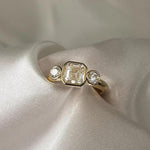 Load image into Gallery viewer, Asscher Cut Trilogy Diamond Engagement Ring featuring a 1.5ct IGI Certified Asscher Cut Lab Grown Diamond with round lab grown diamond side stones in solid gold. Three-stone engagement ring with 1.82ct total carat weight.